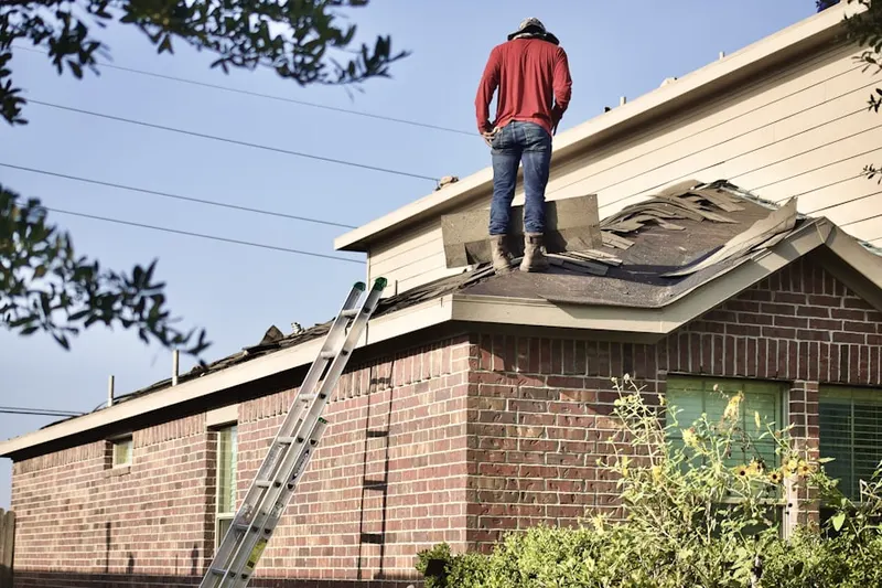 Professional roofer working on a residential roof in Eastvale